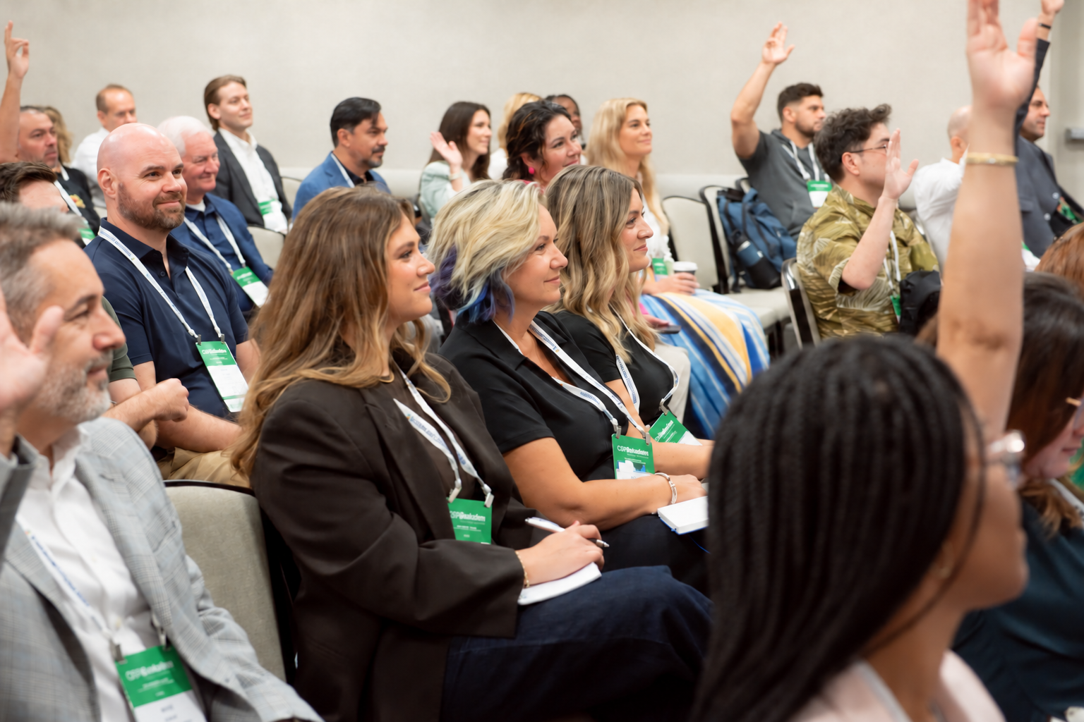 Marketing leaders listening and raising questions during an RRMC conference session